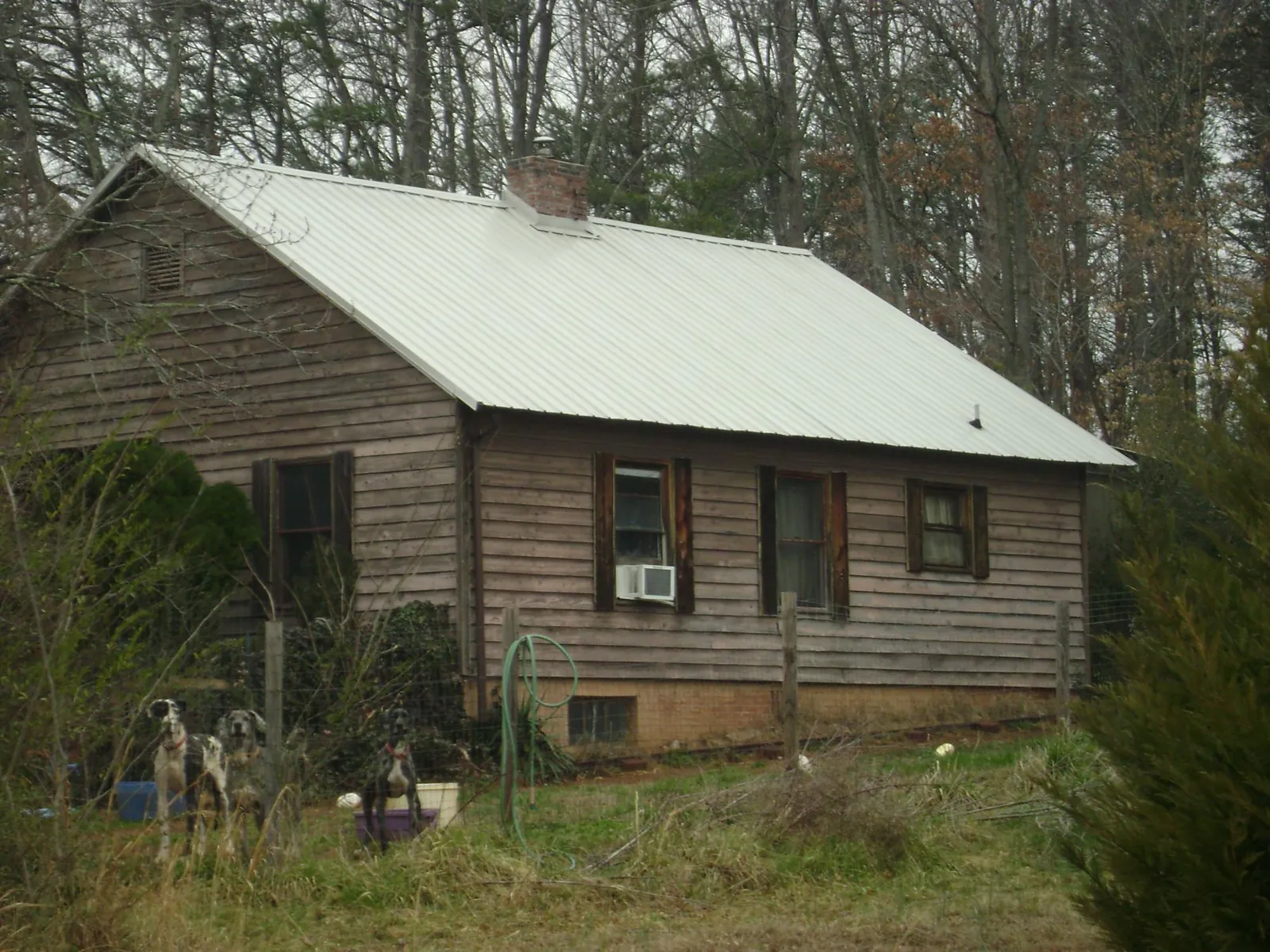 White metal roof on an old wood sided farmhouse, from a Metal Roof Installation job in New Castle